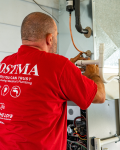 Licensed HVAC technician performing furnace repair and heating system maintenance in Chatham-Kent Ontario home.