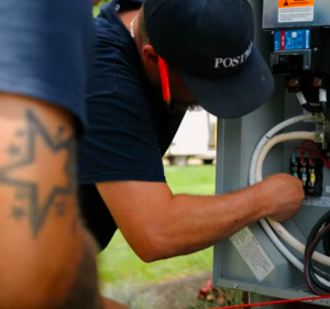 Licensed commercial electrician performing maintenance on a generator for a commercial building