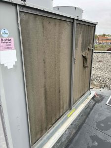 Dirty rooftop AC unit at a commercial property with clogged coils during spring air conditioner maintenance in Chatham-Kent