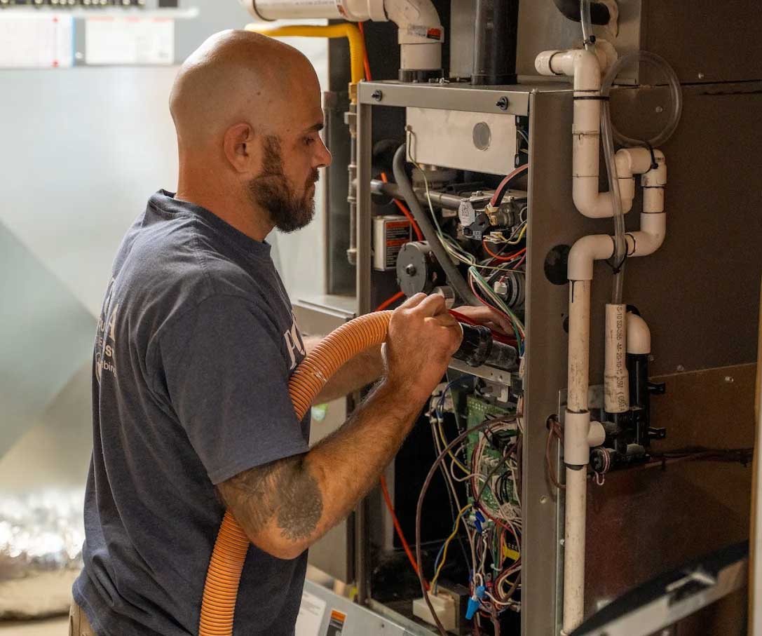 Postma technician servicing HVAC system